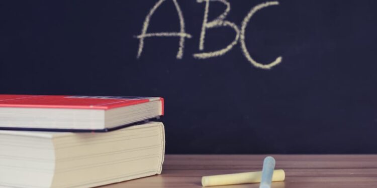 Two books beside two chalks