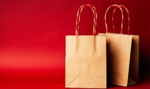 Two brown paper bags on a red background