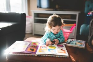 A child reading a book alone