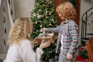 Mother giving a christmas gift to her son