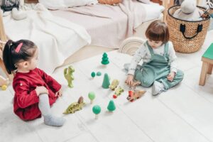 Kids playing on the floor with their toys