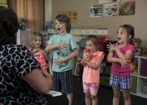 Kids singing with their teacher
