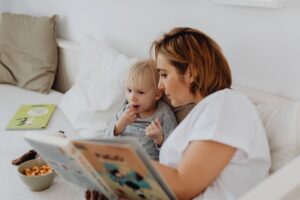 Mother reads fairytale on her daughter