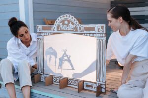 Woman performing a puppet show for their children