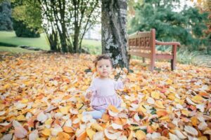 Toddler sitting on the leaves