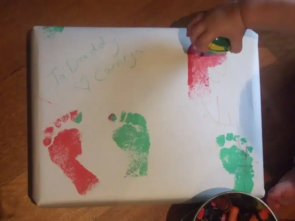 Box Wrapped In A White Paper With Colored Footprints 
