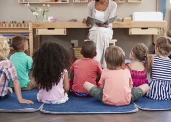 Teacher Reading Book on the Children. Reading with Silly Voices