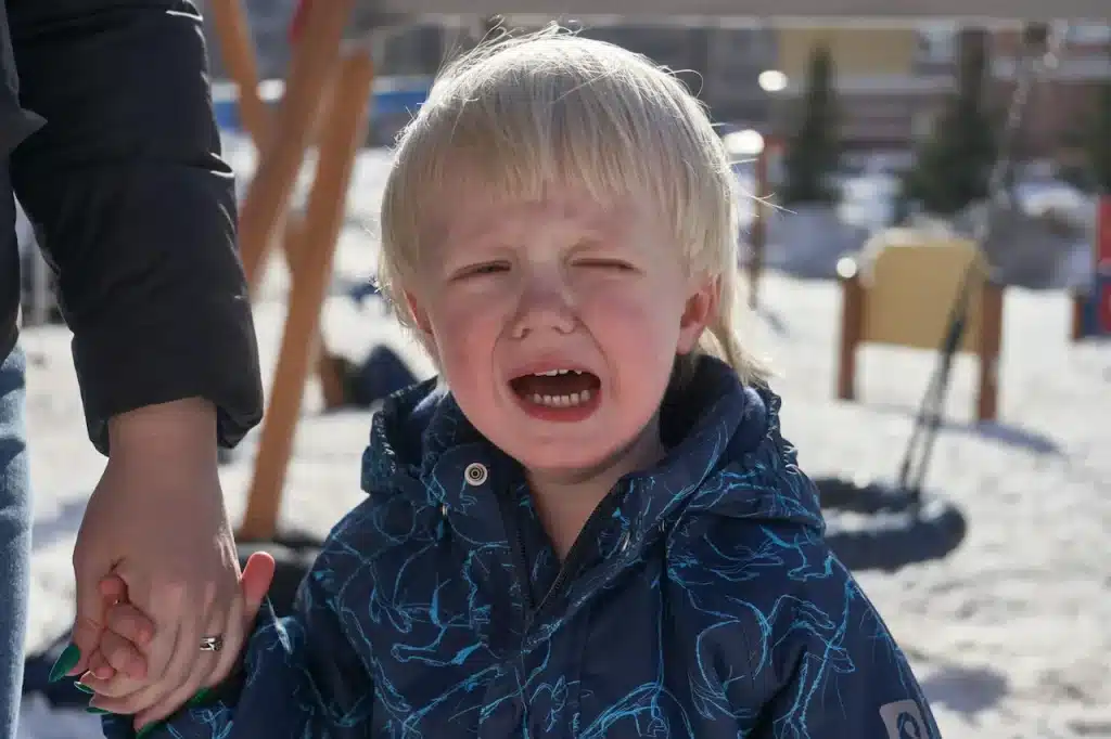 A Little Boy Crying While Walking Through The School