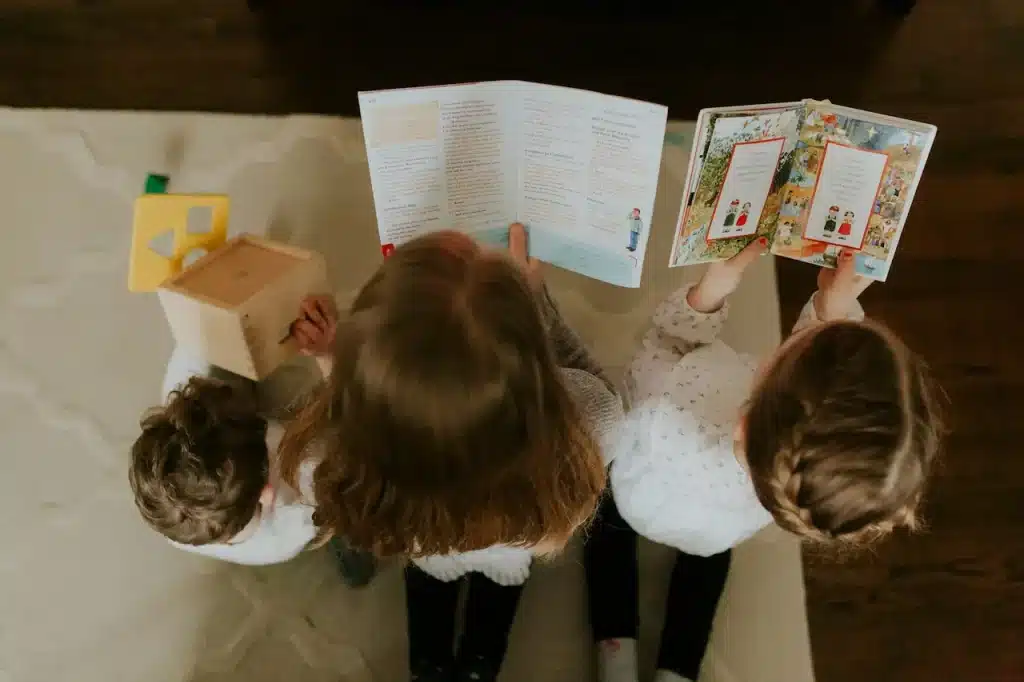 Three children reading books together